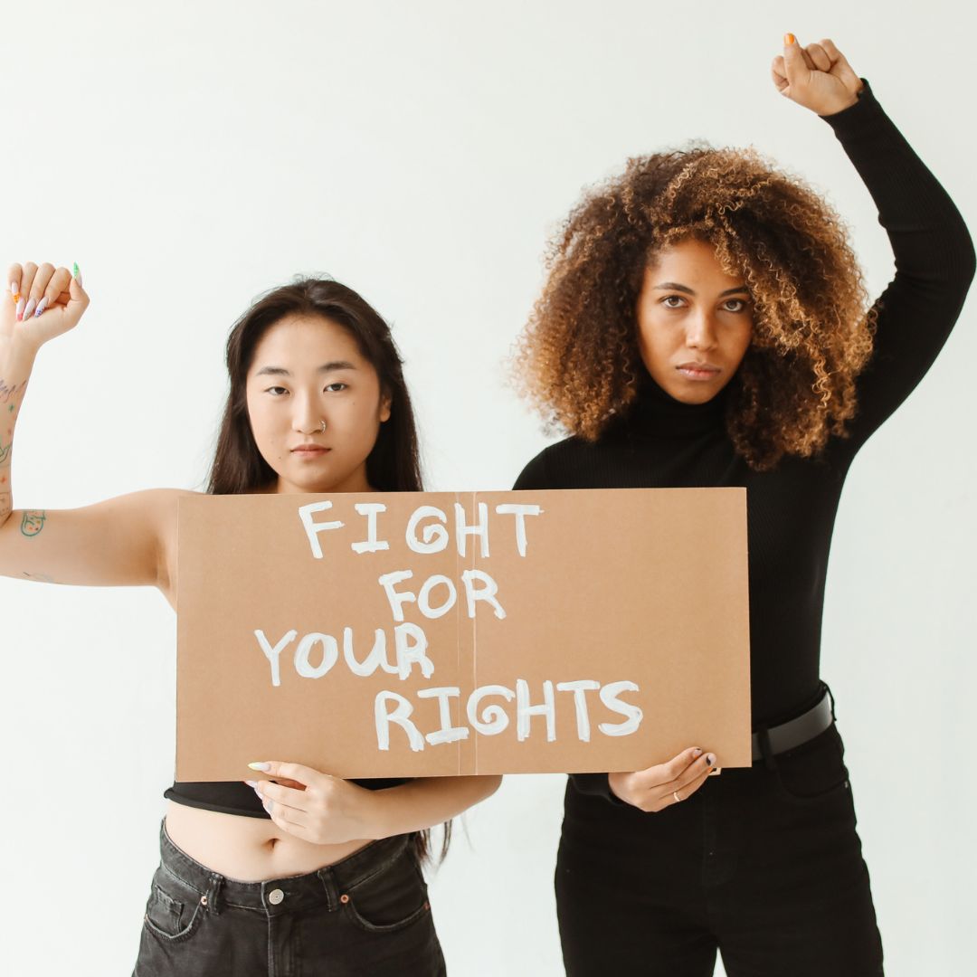 Two women holding a sign that says fight for your rights